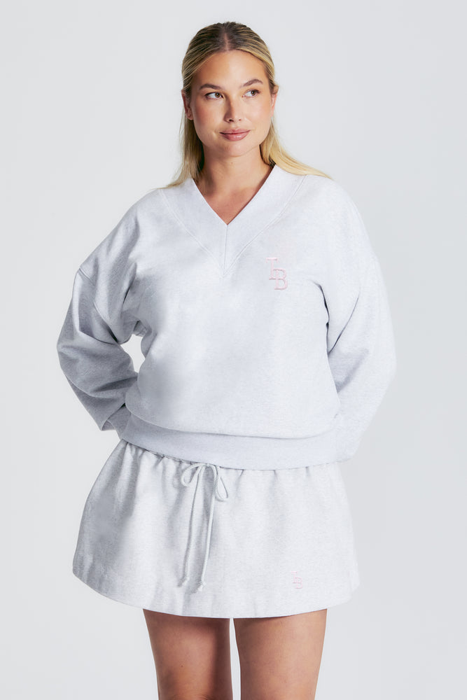 
                  
                    Load image into Gallery viewer, ASIA V NECK SWEATSHIRT LT HEATHER GREY/BLUSH
                  
                